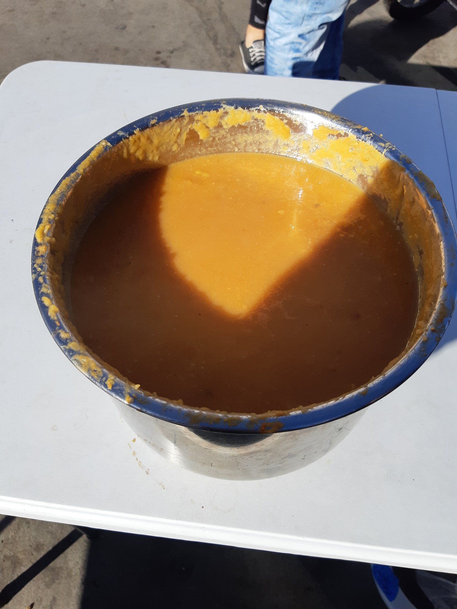 A large serving bowl of pumpkin soup.