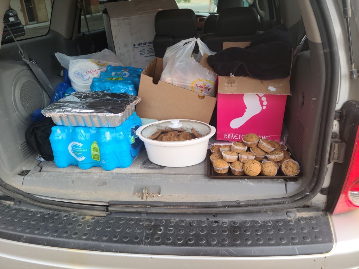 Food and water bottles in the trunk of a vehicle.